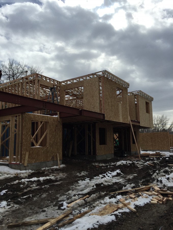 Wood framing at the cantilevers. Notice the floor framing extending past. The walls will also be sloped to hide this.