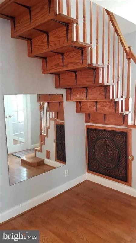 An example of a bad DIY floating stair. Bookshelf brackets seem to be all that is holding up the stair treads.
