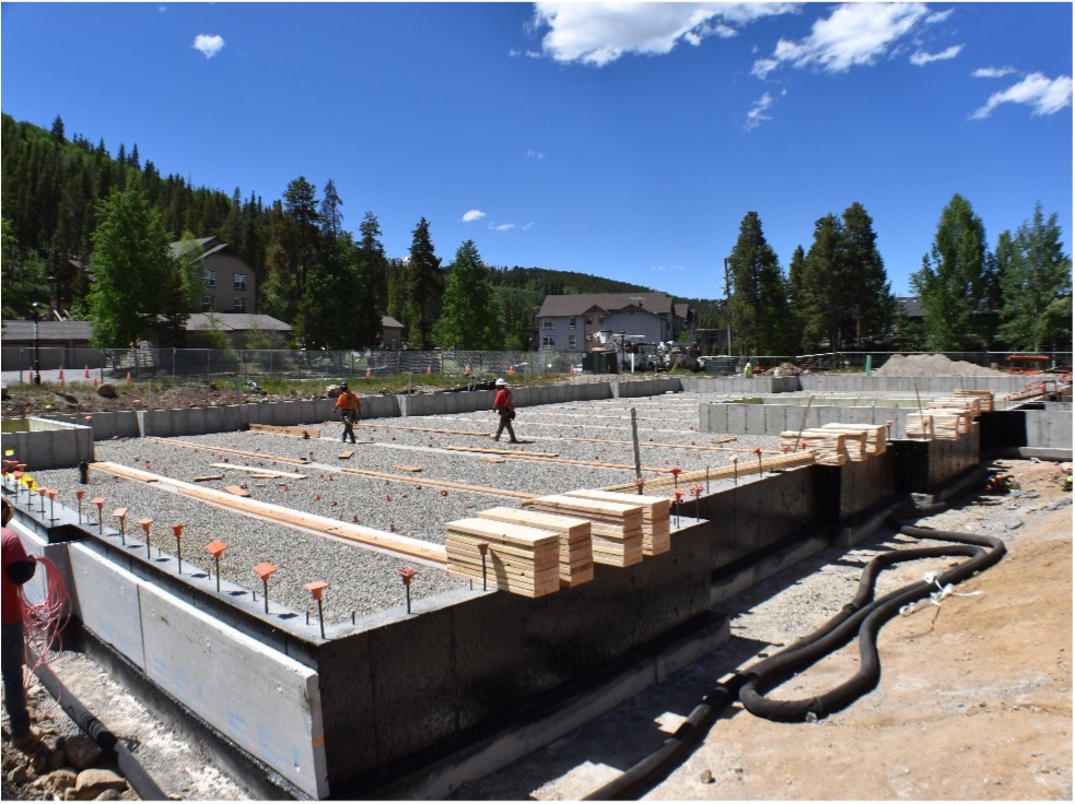 Concrete foundation being poured for a modular site.