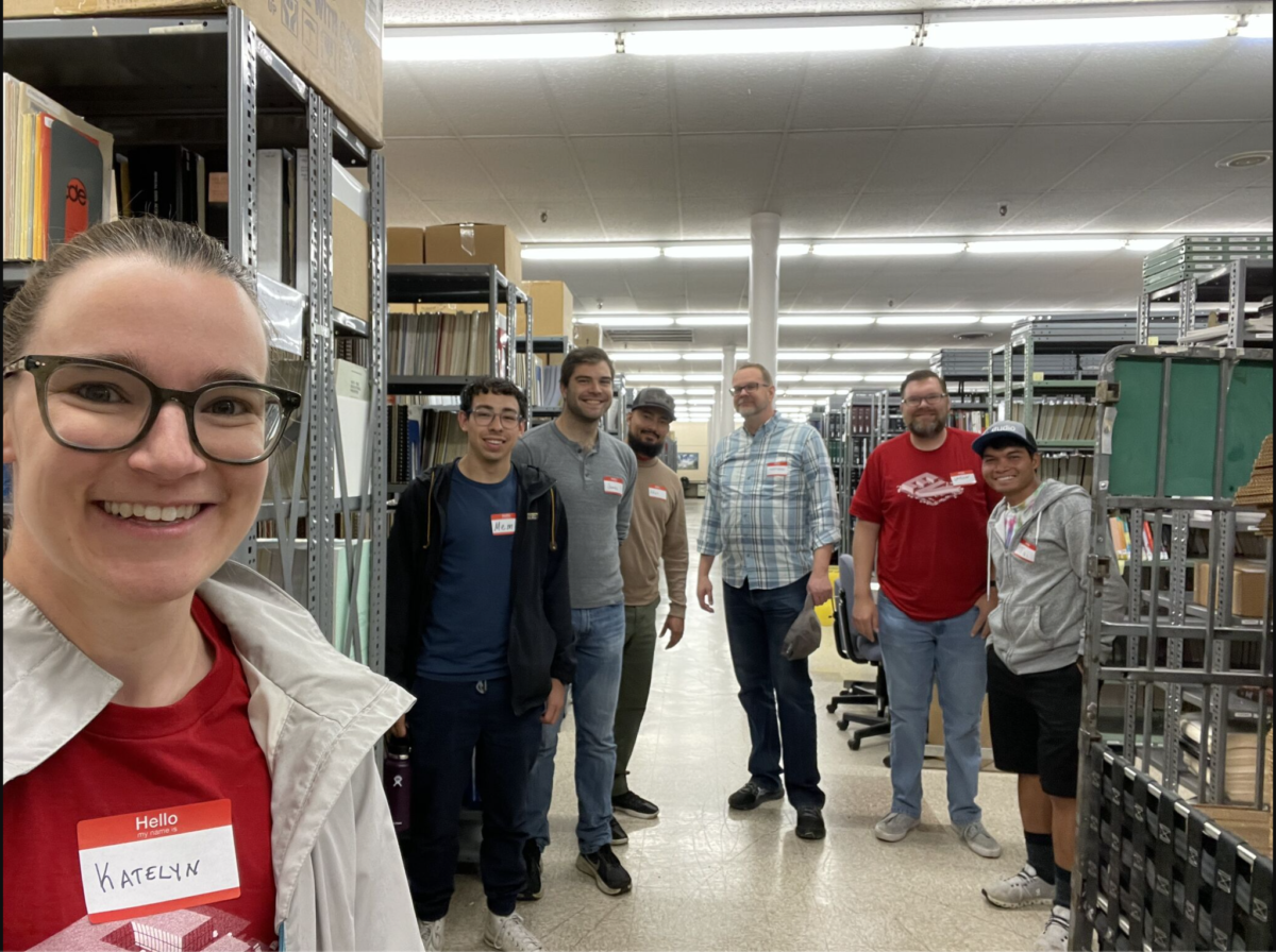 A group of volunteers from EVstudio are pictured in a selfie in the Colorado Talking Book Library.