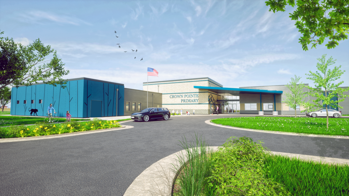 Exterior Render of Crown Pointe Primary. The exterior materials include tan and blue masonry, fiber cement siding, and blue cement stucco with custom angled reveals and cougar cutouts that nod to the school mascot and the surrounding mountainous landscape. 