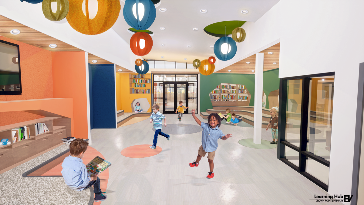 The interior layout is oriented by age group, with hallway alcoves color-coded to assist with wayfinding and to create spaces where students can collaborate with teachers. These vibrant colors extend into the central learning hub, which serves as a pocket library and gathering area for the entire school community.