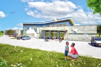 Exterior rendering of TLC Early Learning Collaborative - features grey fiber cement panels and blue and green stucco that echoes the surrounding mountains. A butterfly roof adds a unique and exciting element for students and staff alike.