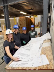 Four EVstudio employees looking over plans at Boulder MOD