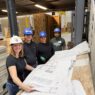 Four EVstudio employees looking over plans at Boulder MOD
