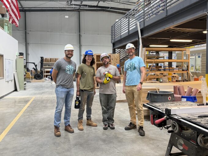 Four EVstudio employees standing in the Boulder MOD factory