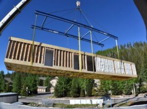 A modular set piece being placed at the site of a multi-family build