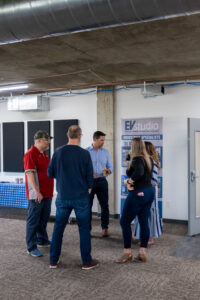 EVstudio and Fransen Pittman happy hour attendees talking in the EVstudio Denver office