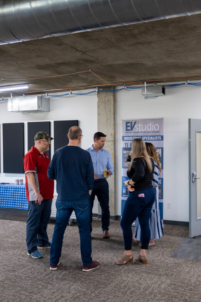 EVstudio and Fransen Pittman happy hour attendees talking in the EVstudio Denver office