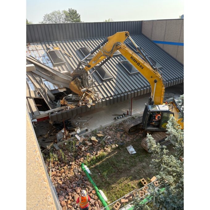 A crane works to demolish the north building of Westgate Community School
