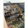 A crane works to demolish the north building of Westgate Community School