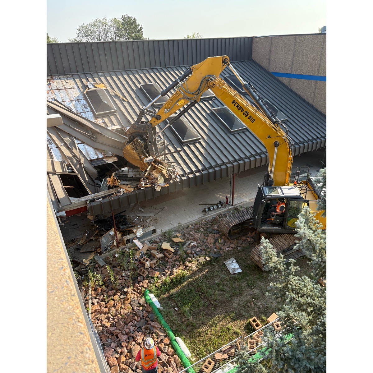 A crane works to demolish the north building of Westgate Community School