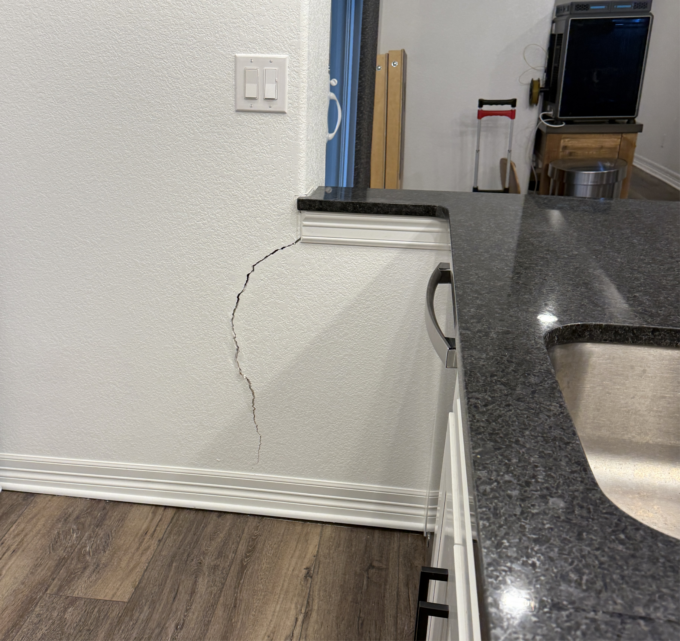 Drywall cracking associated with differential basement slab movement.